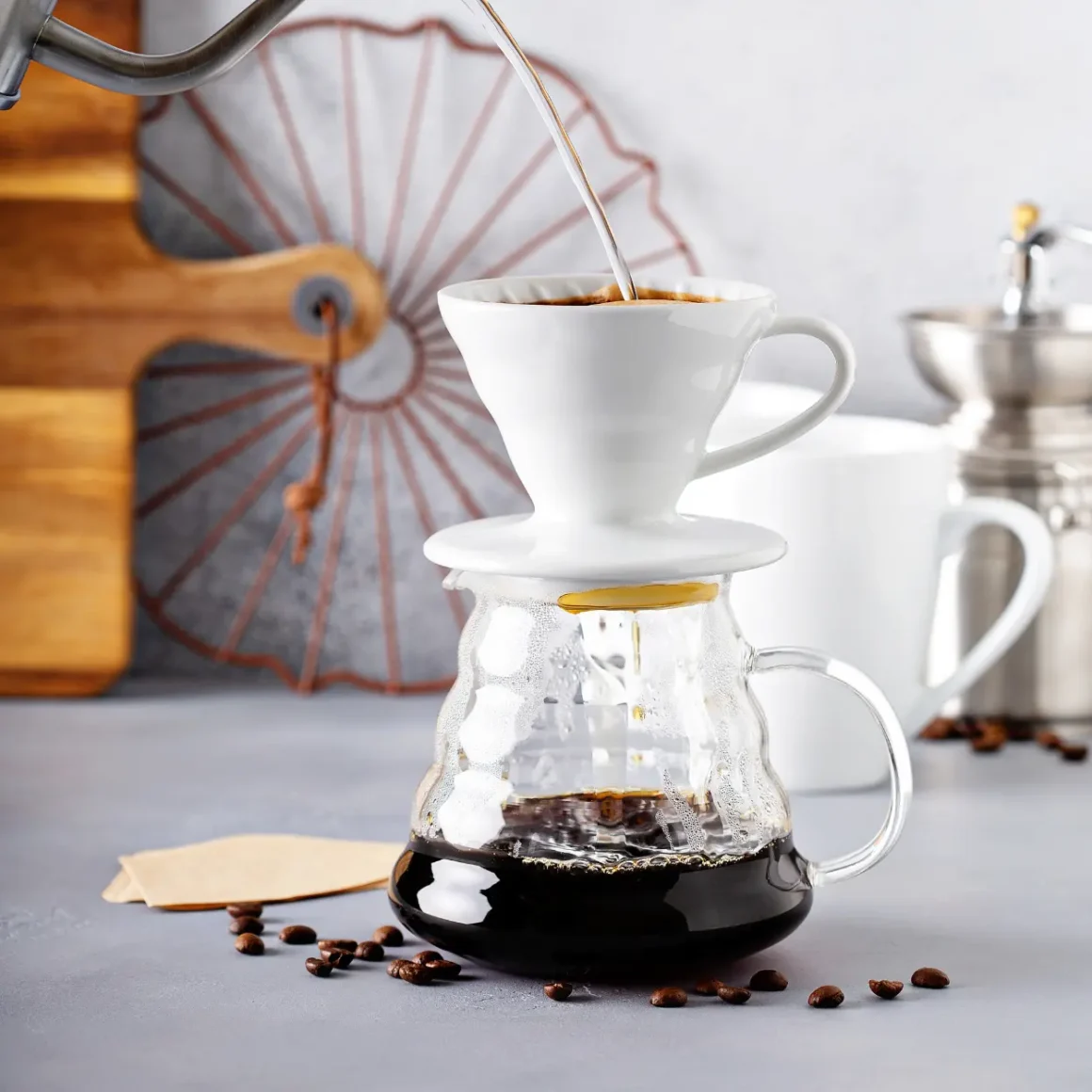 a drip coffee being poured into a glass container