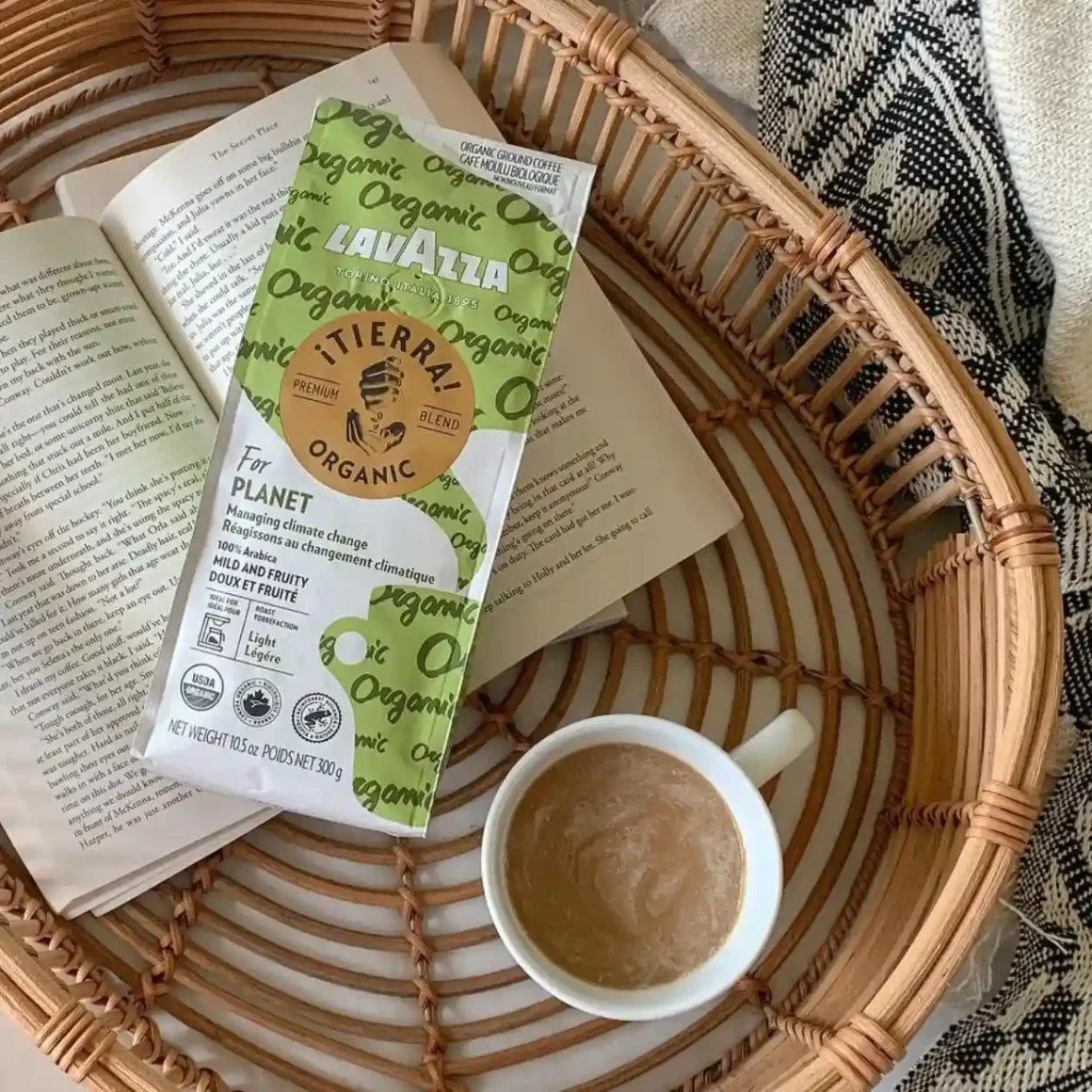 a basket with a book and a cup of lavazza coffee