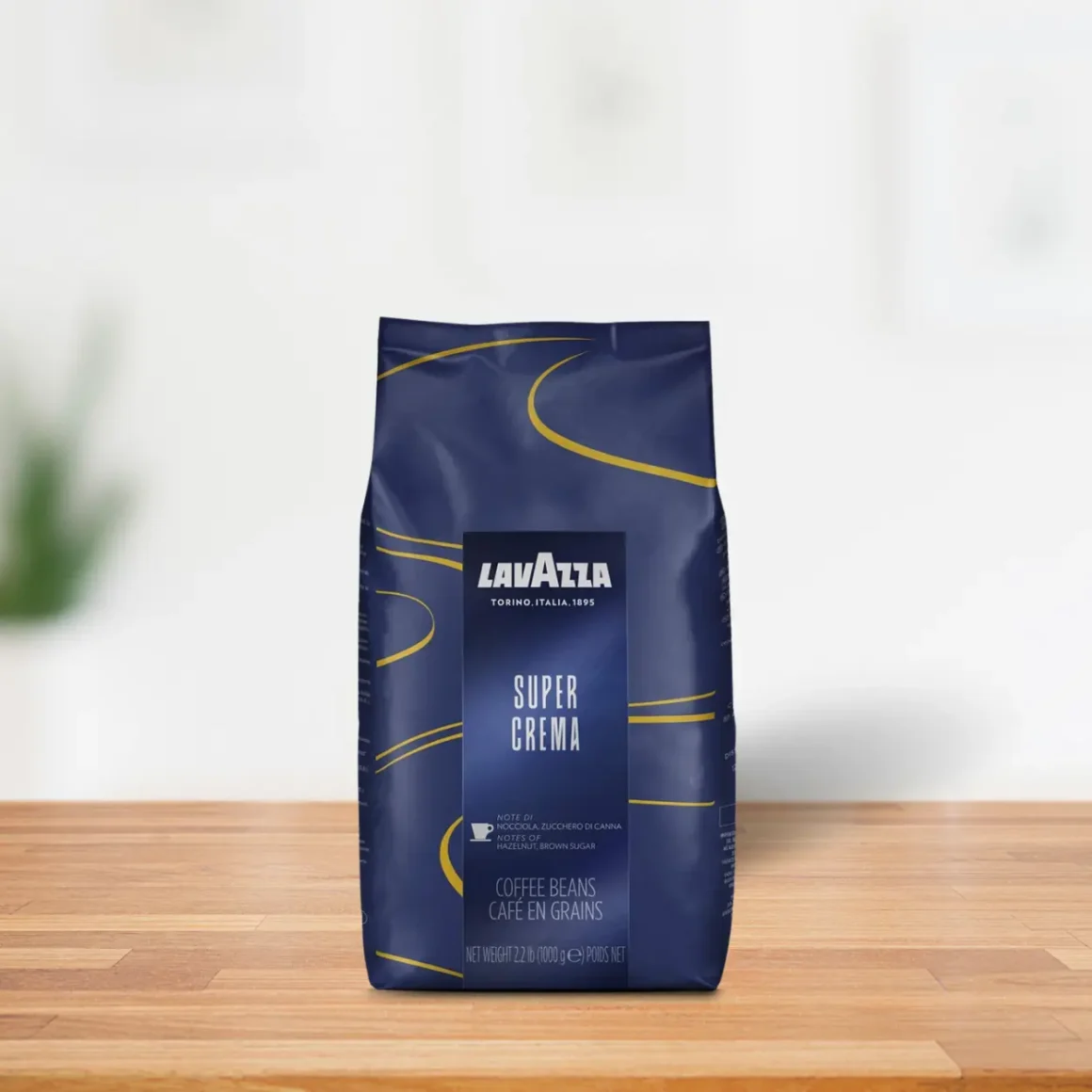 a blue bag of lavazza super crema coffee on a wooden surface
