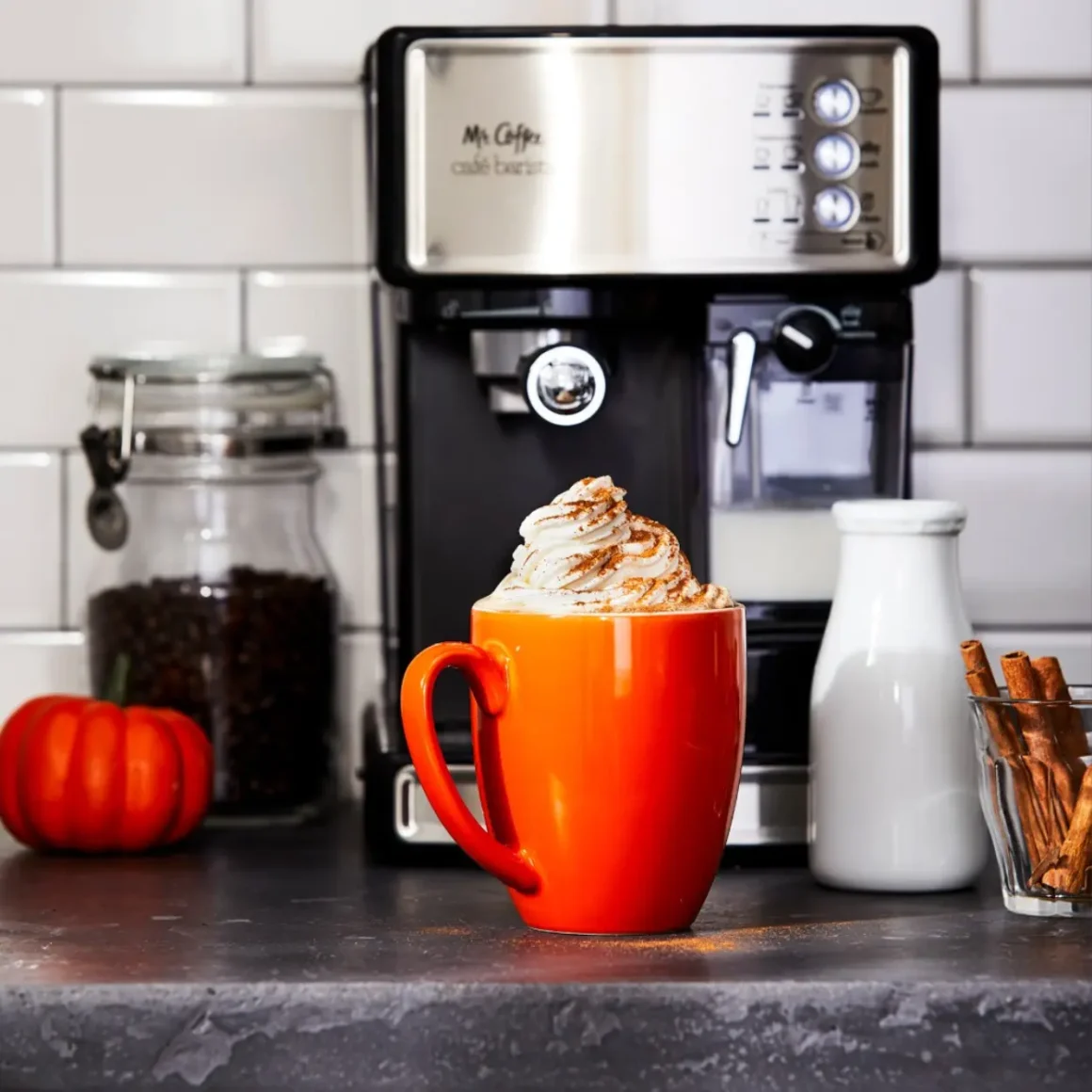 a mr. coffee cafe barista espresso machine and cookies on a plate