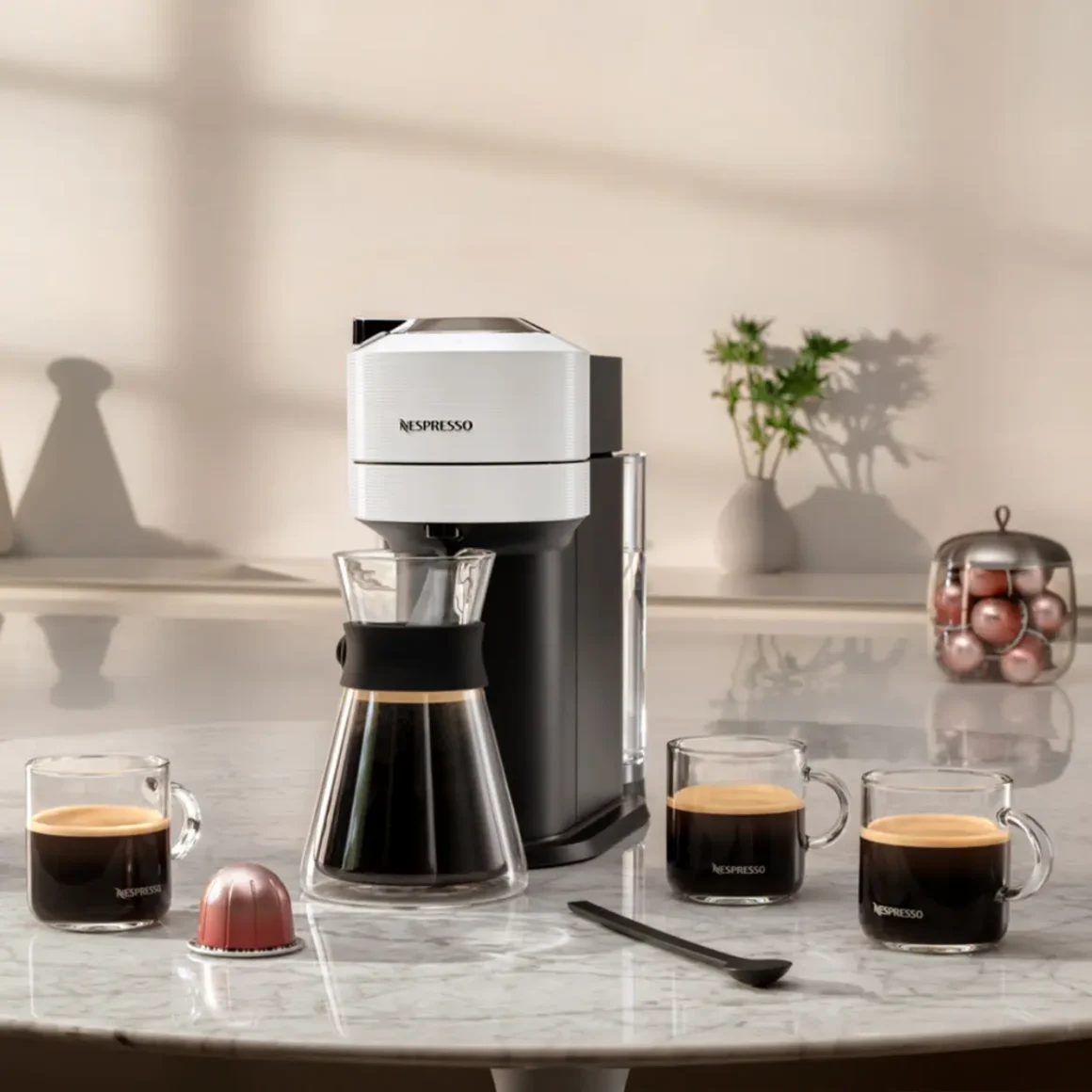 a nespresso vertuo next coffee machine and cups on a table