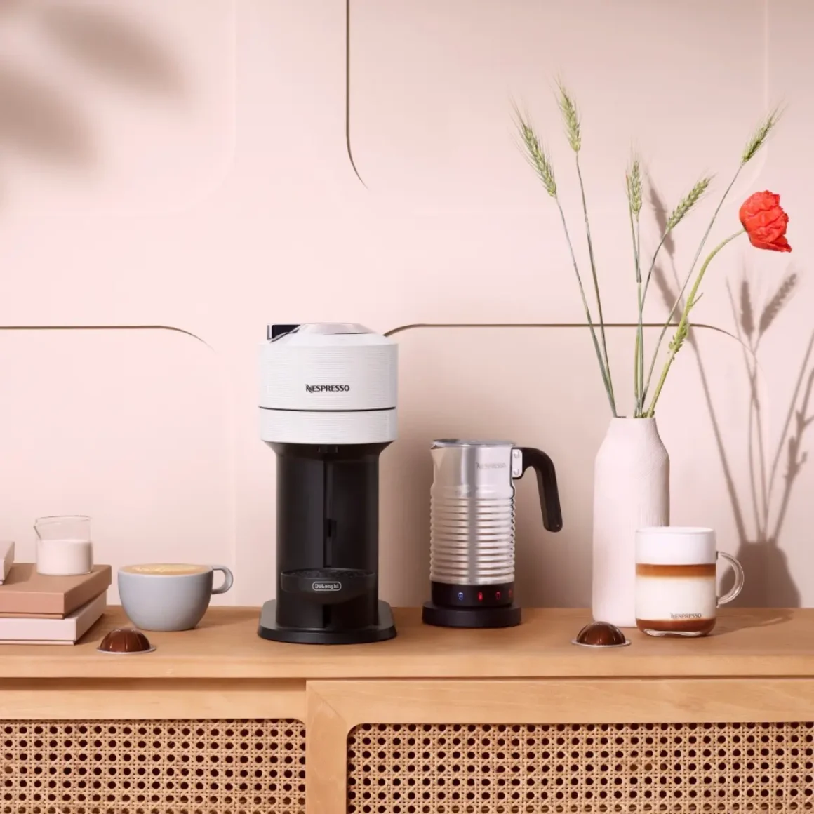 a nespresso vertuo next coffee machine and coffee pot on a table