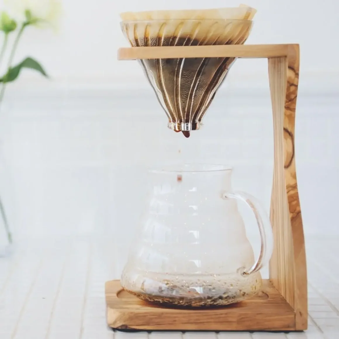 a pour over coffee stand with a wooden body