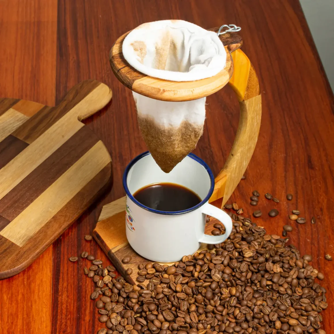 a coffee being poured into a cup from a chorreador
