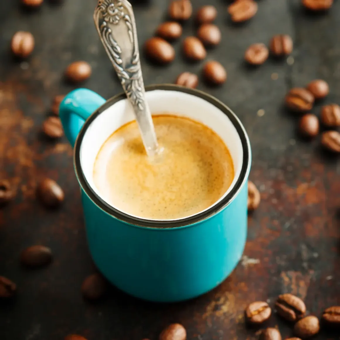 a cup of blonde espresso with a spoon