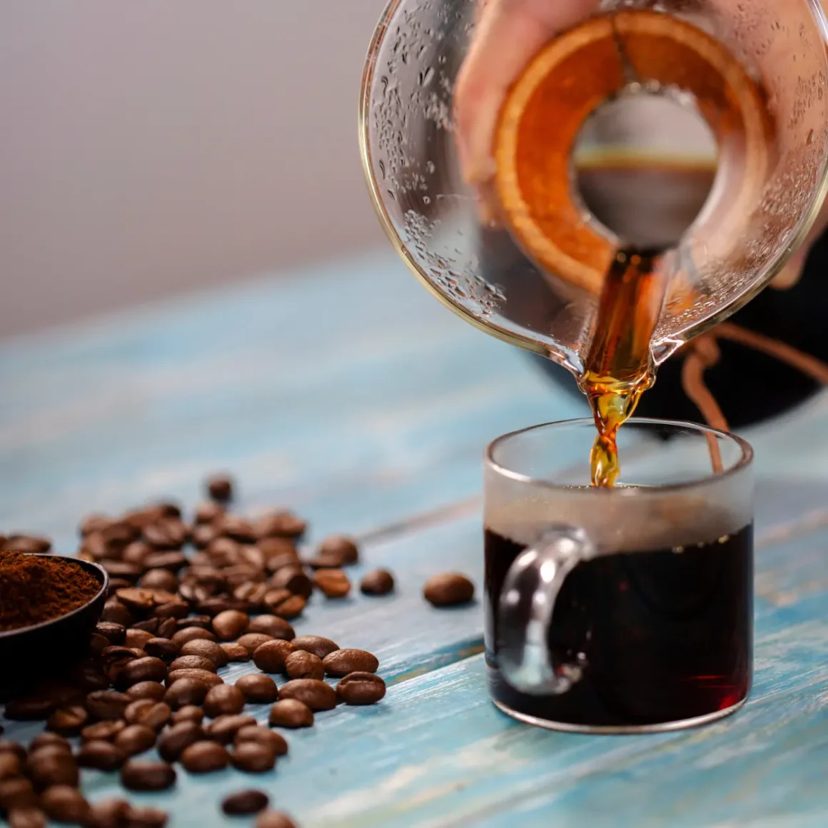 a person pouring coffee into a cup