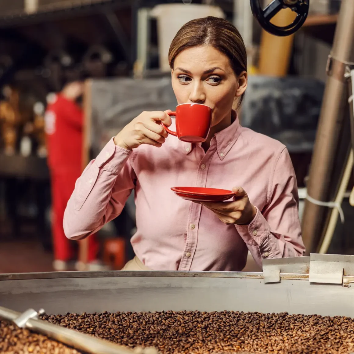 woman drinking coffee from a red cup