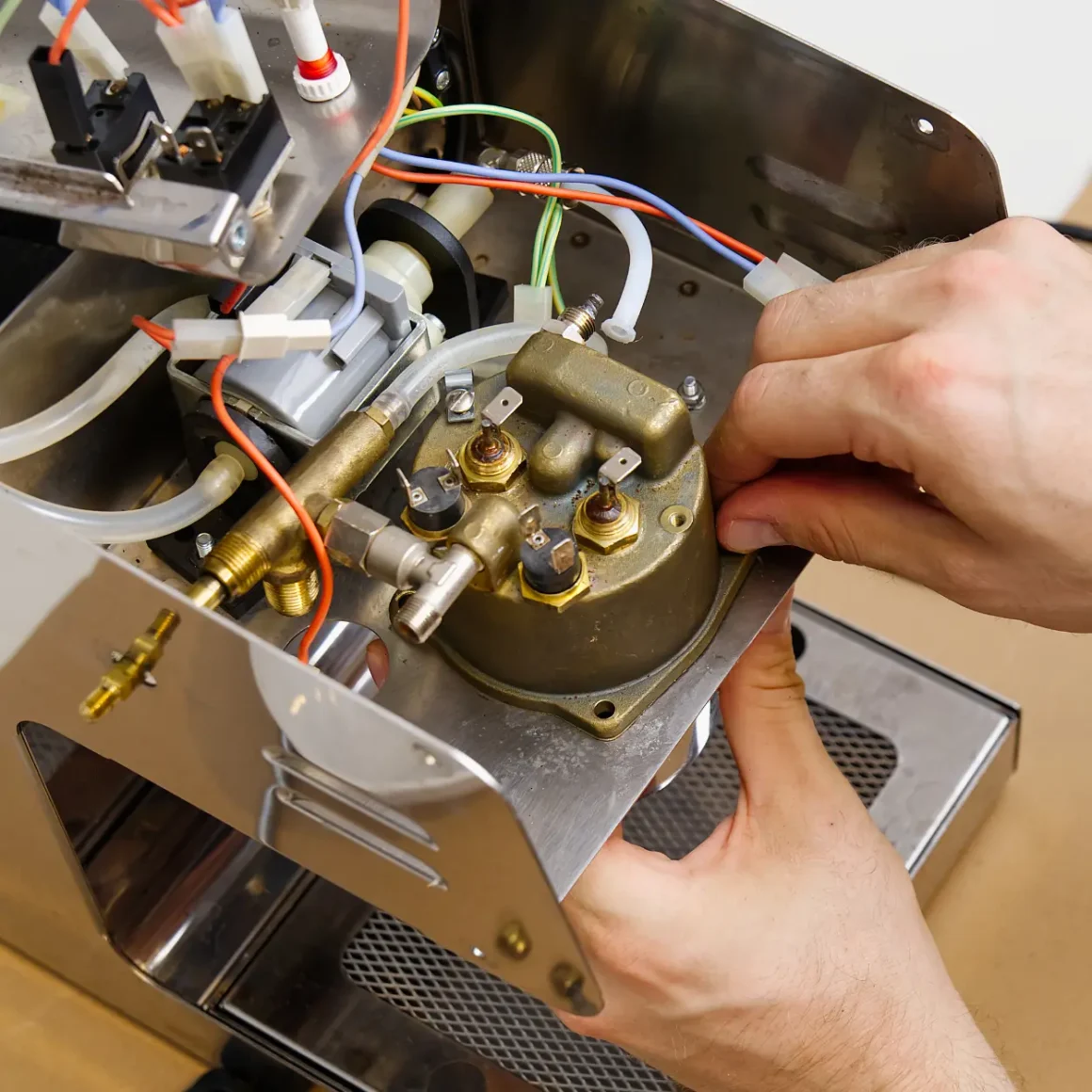 a person repairing an espresso machine