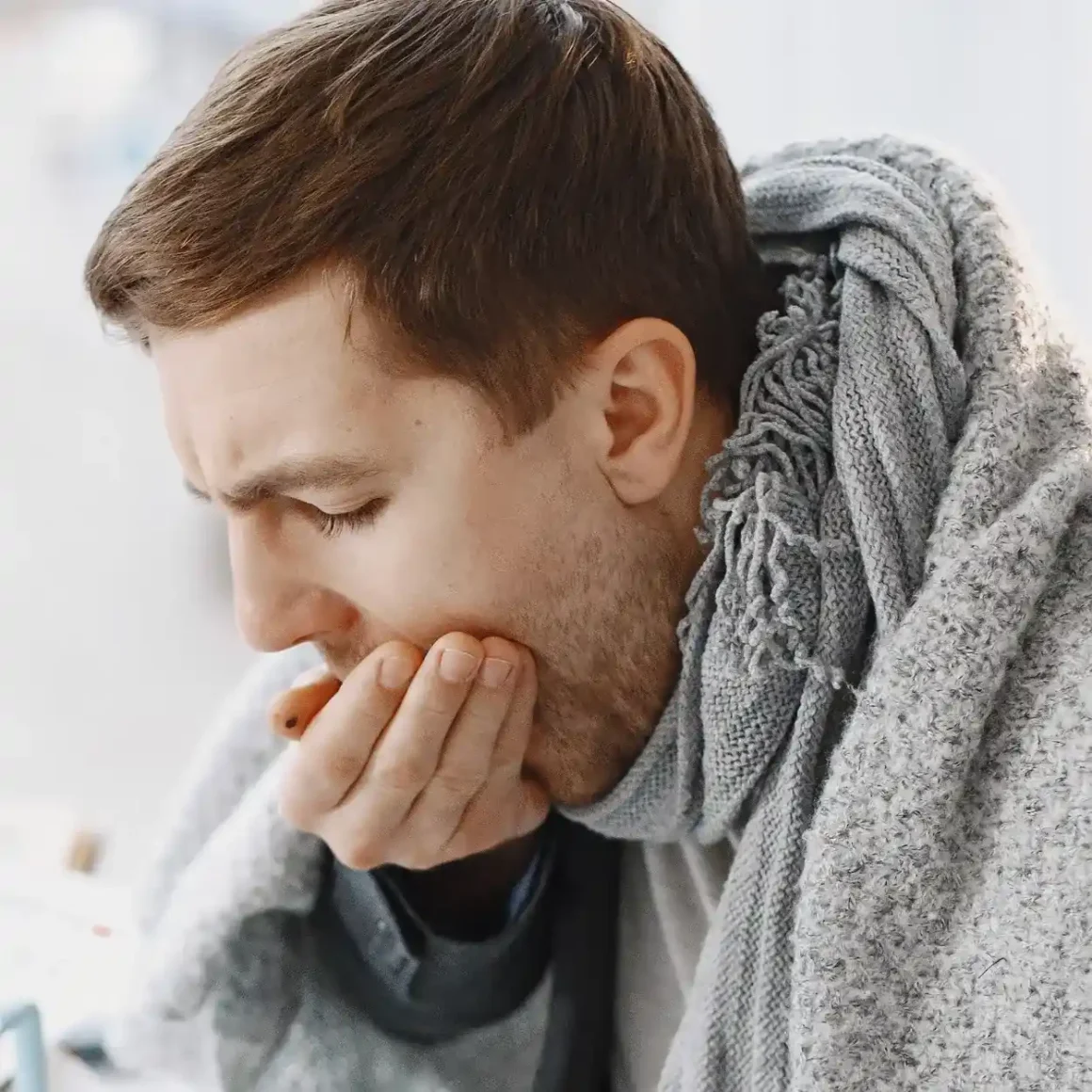 a person with a scarf covering his mouth