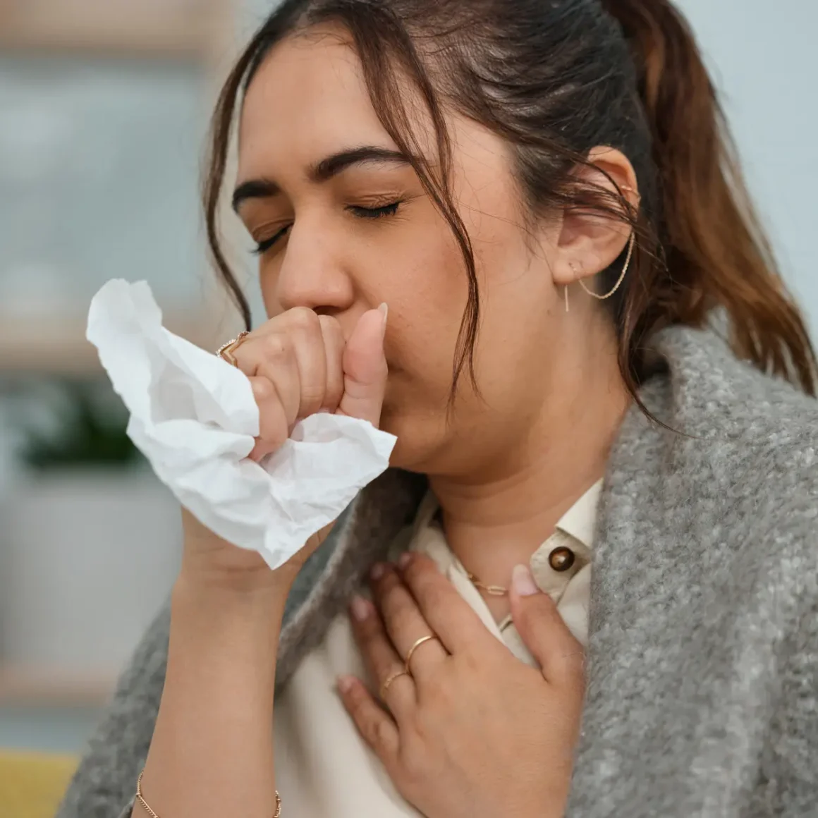 a woman blowing her nose