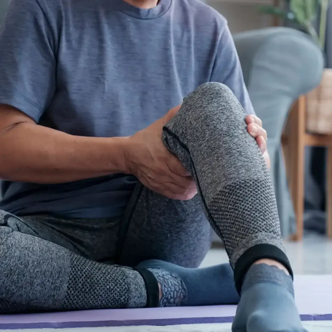 a person sitting on a yoga mat