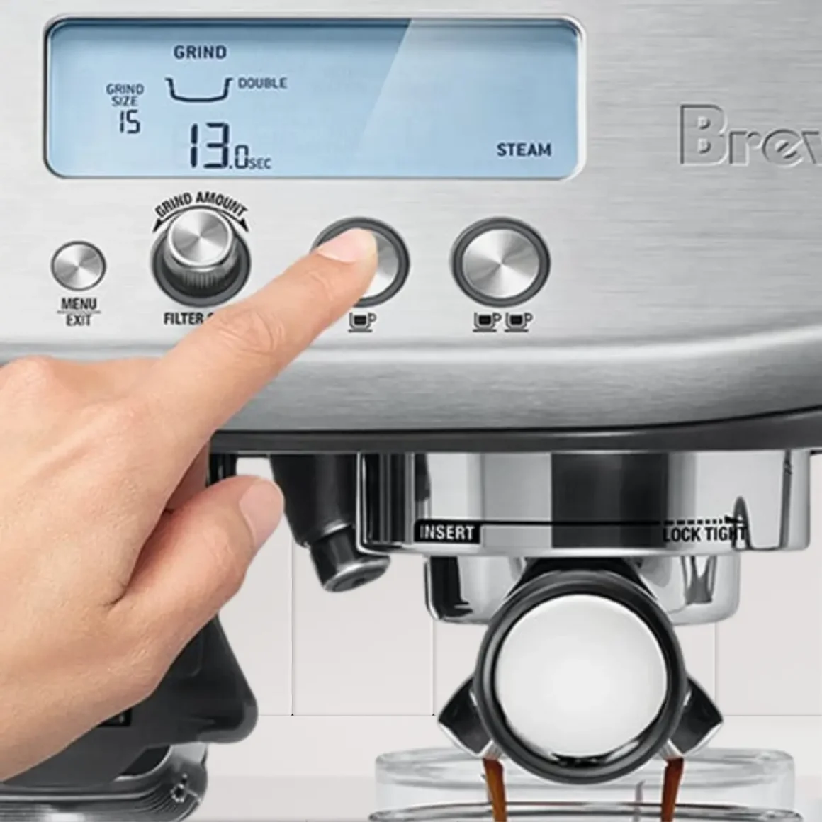 a hand pressing a button on a breville barista pro espresso machine