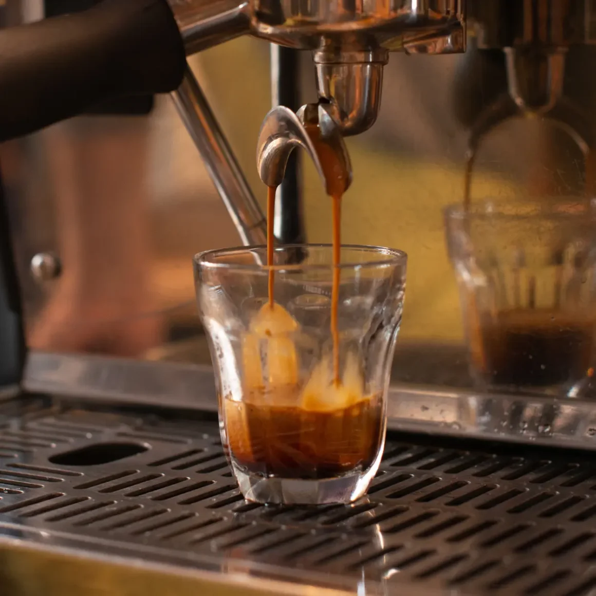 espresso machine pouring coffee in a shot glass