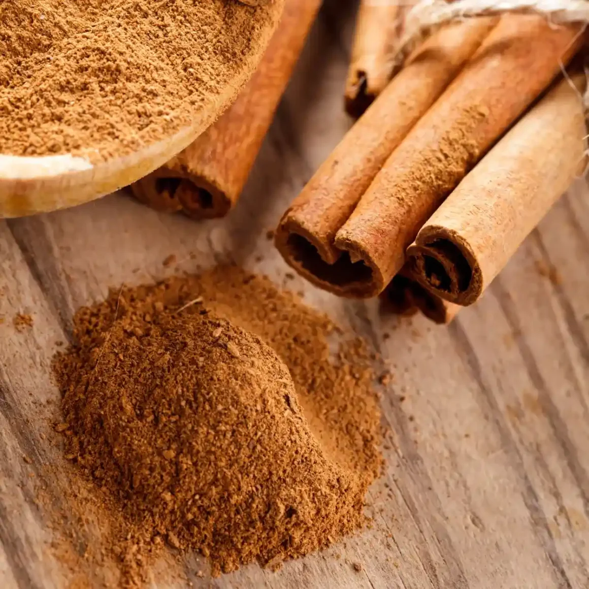 a pile of cinnamon sticks and powder