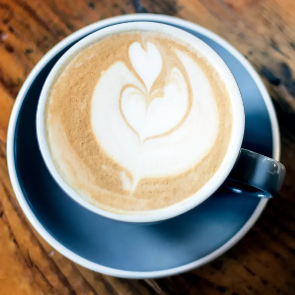 a cup of latte with a heart in the foam