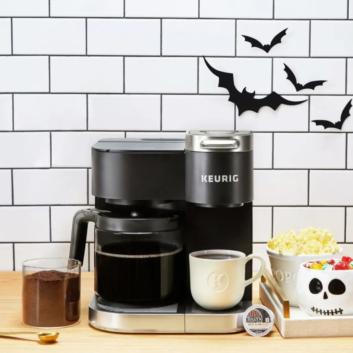 a keurig k-duo single-serve coffee maker with a cup of coffee and popcorn