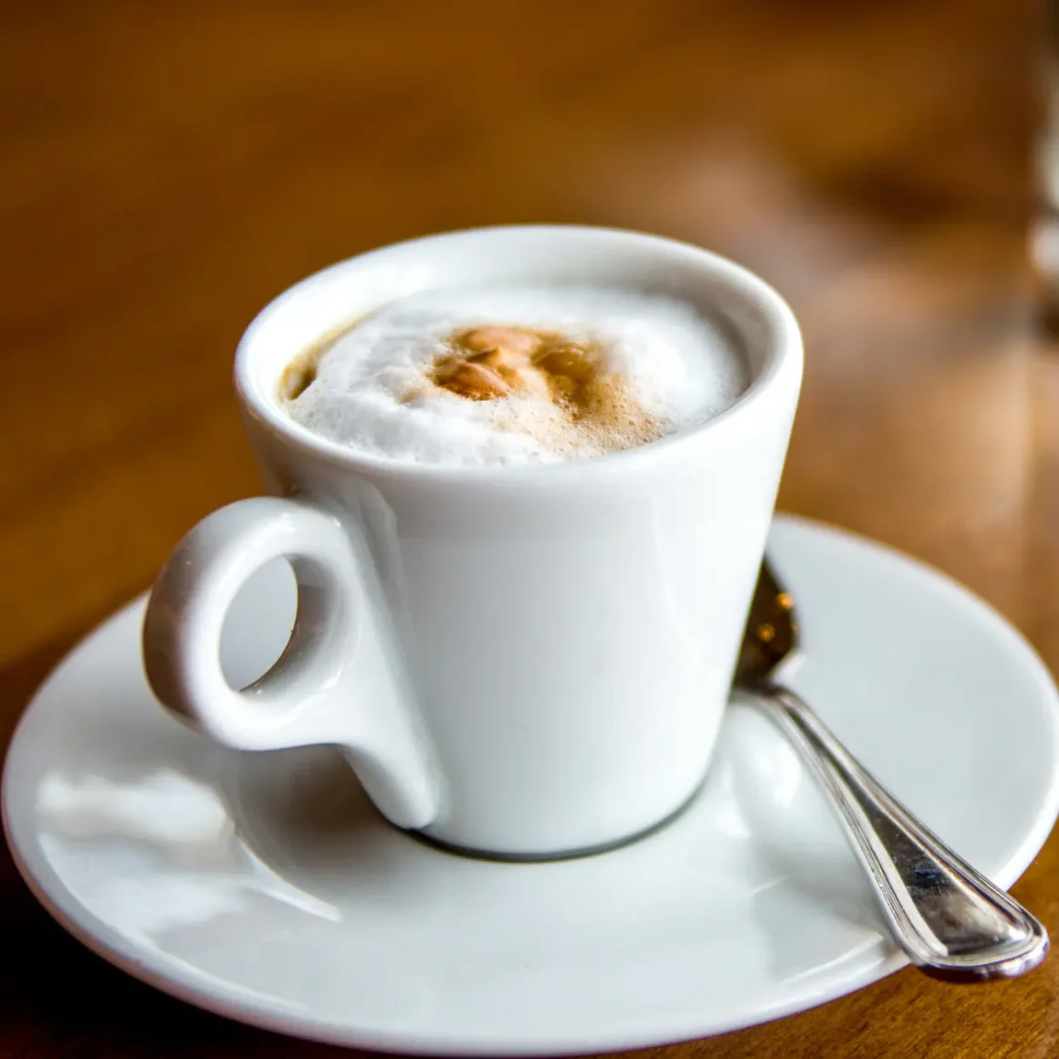 a cup of doppio macchiato with foam in it