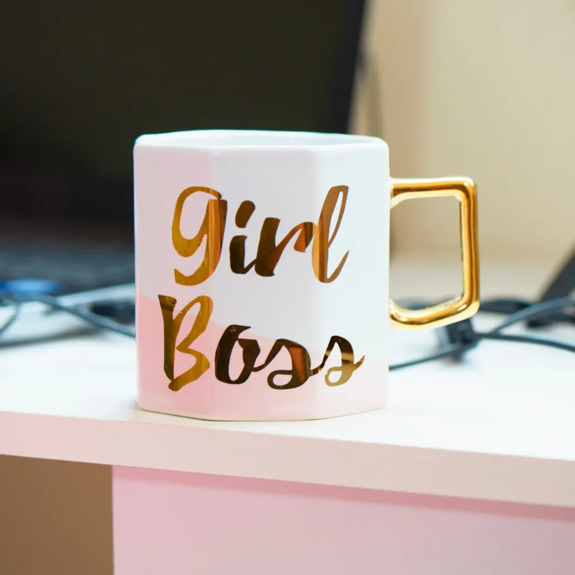 a ceramic mug with gold text on it