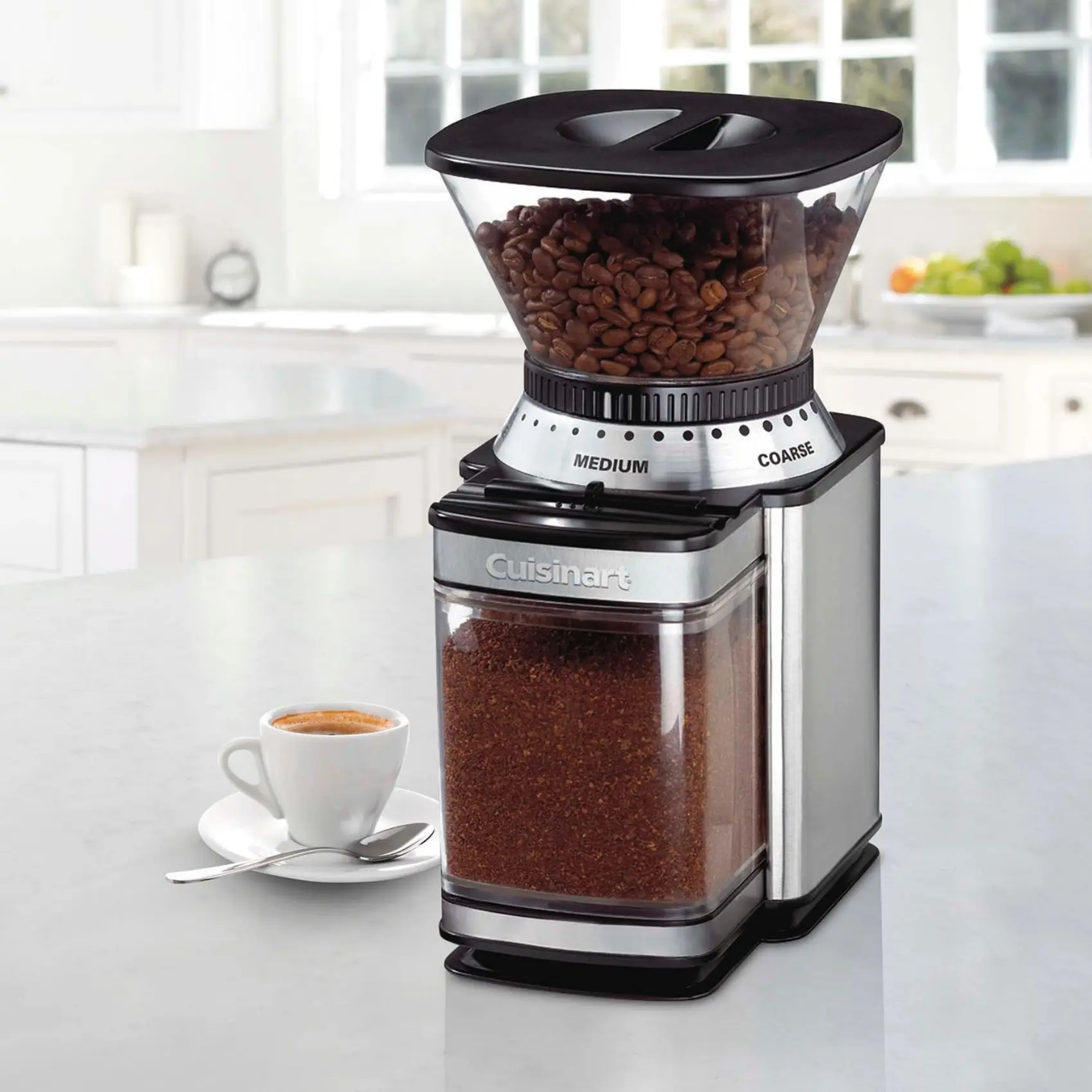 a supreme grind cuisinart burr coffee grinder with a cup of coffee on a saucer