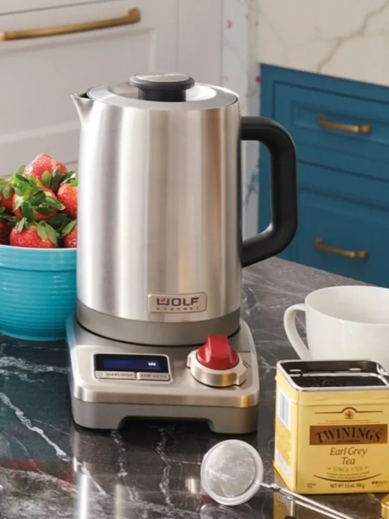 a wolf gourmet true temperature electric kettle and a bowl of strawberries on a counter