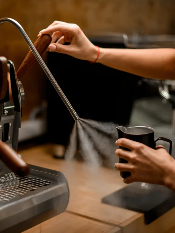 a person using an espresso machine