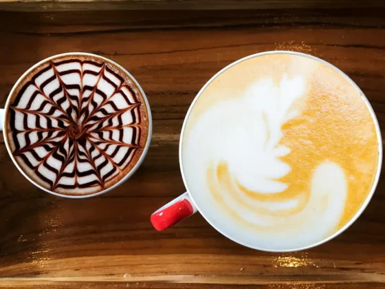 two cups of mocha and latte on a wooden tray