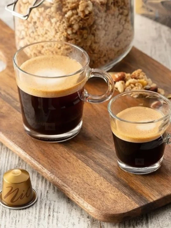 a glass of double espresso and gran lungo on a wooden board