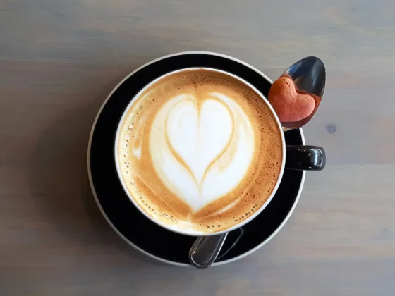 a cup of coffee with a heart design in the foam