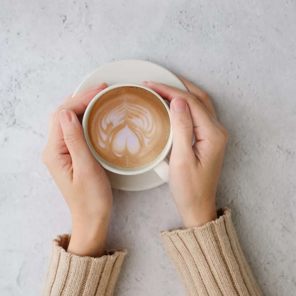 a person holding a cup of coffee