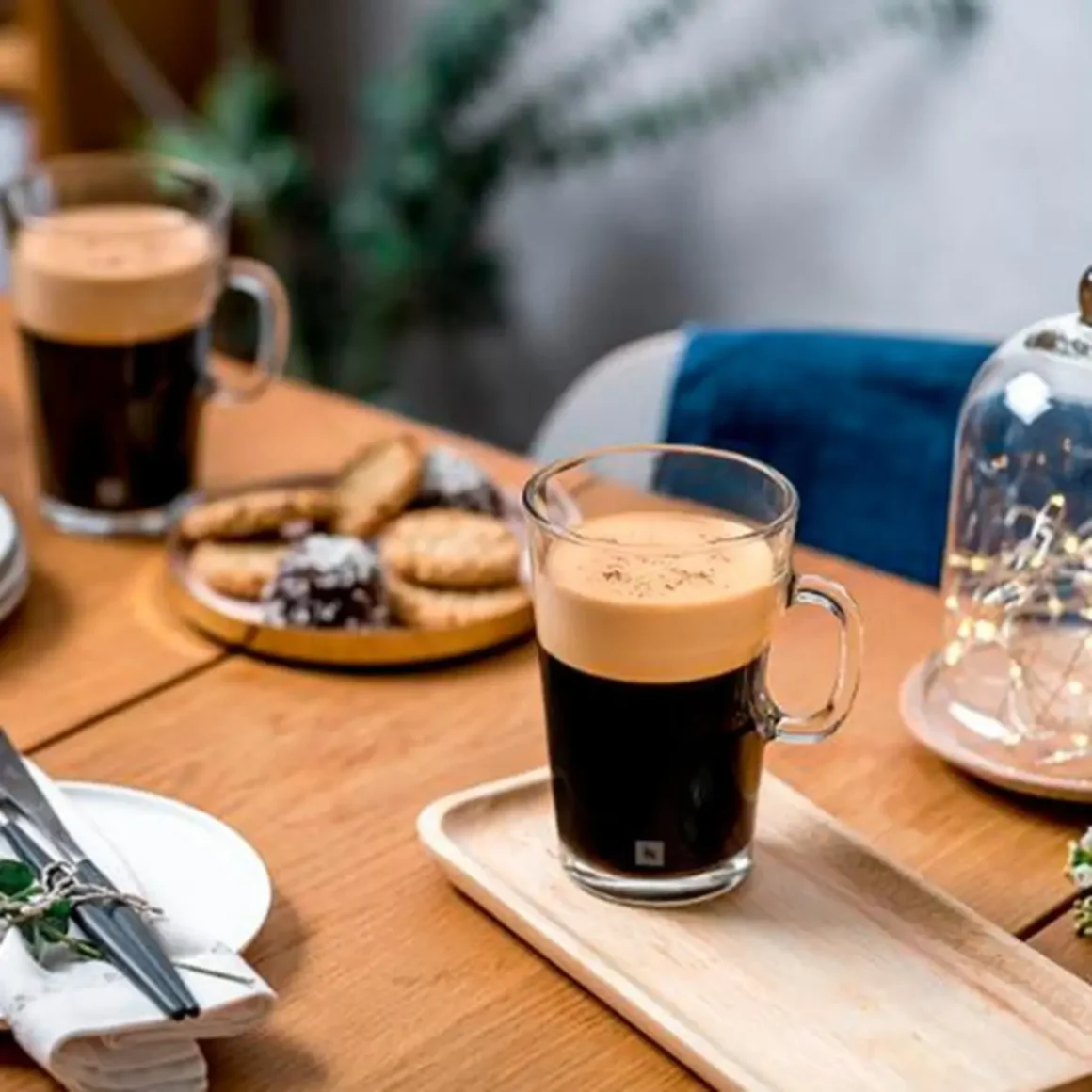 a glass mug with gran lungo on a wooden tray