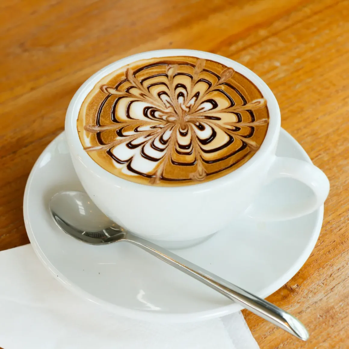 a cup of mocha with a design on top