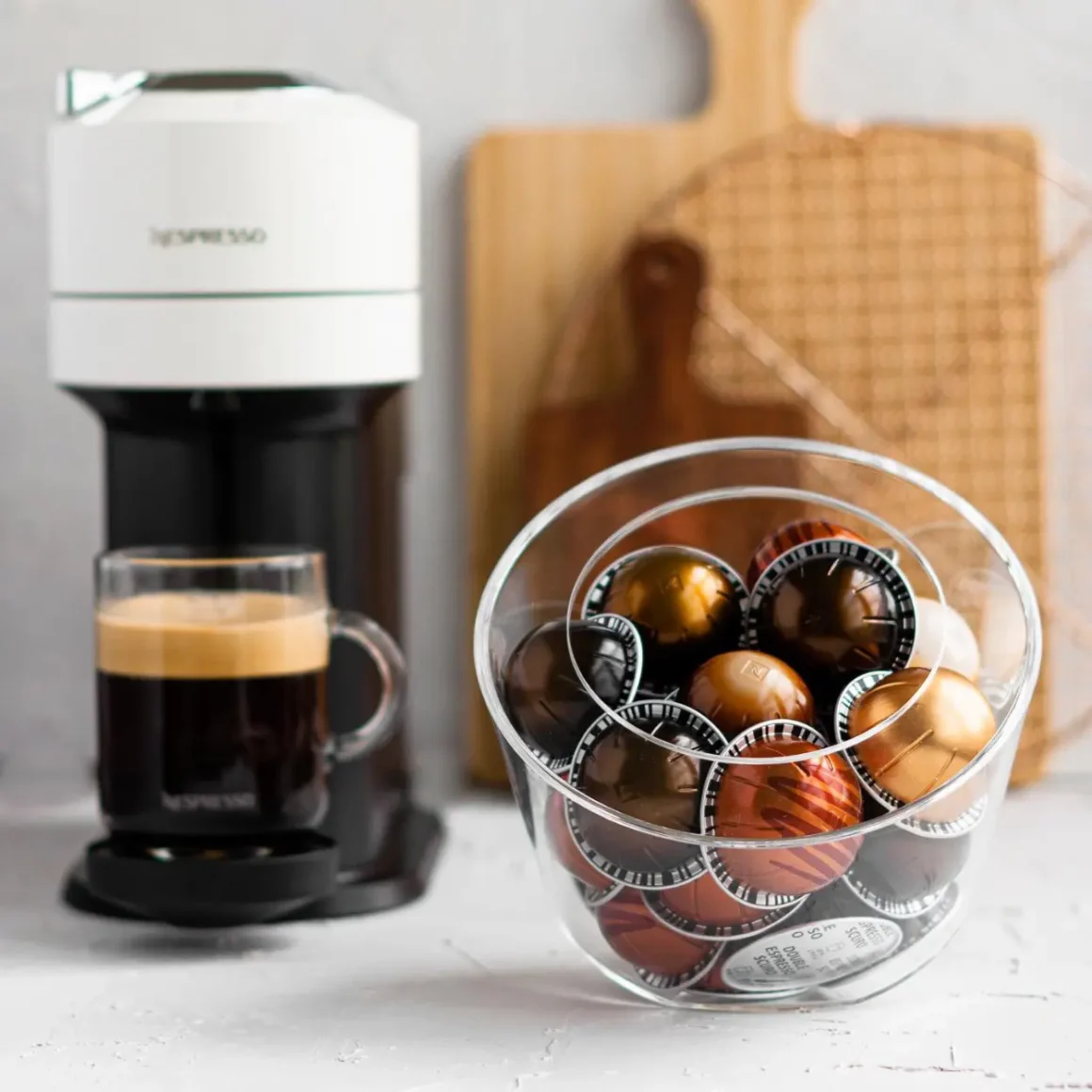 a bowl of nespresso pods and a coffee maker