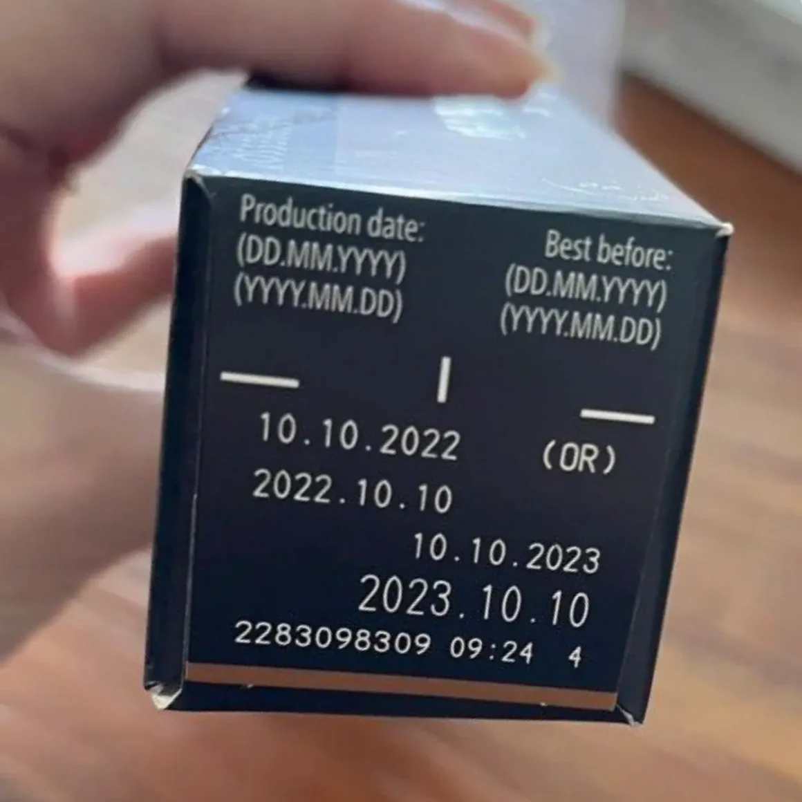 a hand holding a nespresso pods box