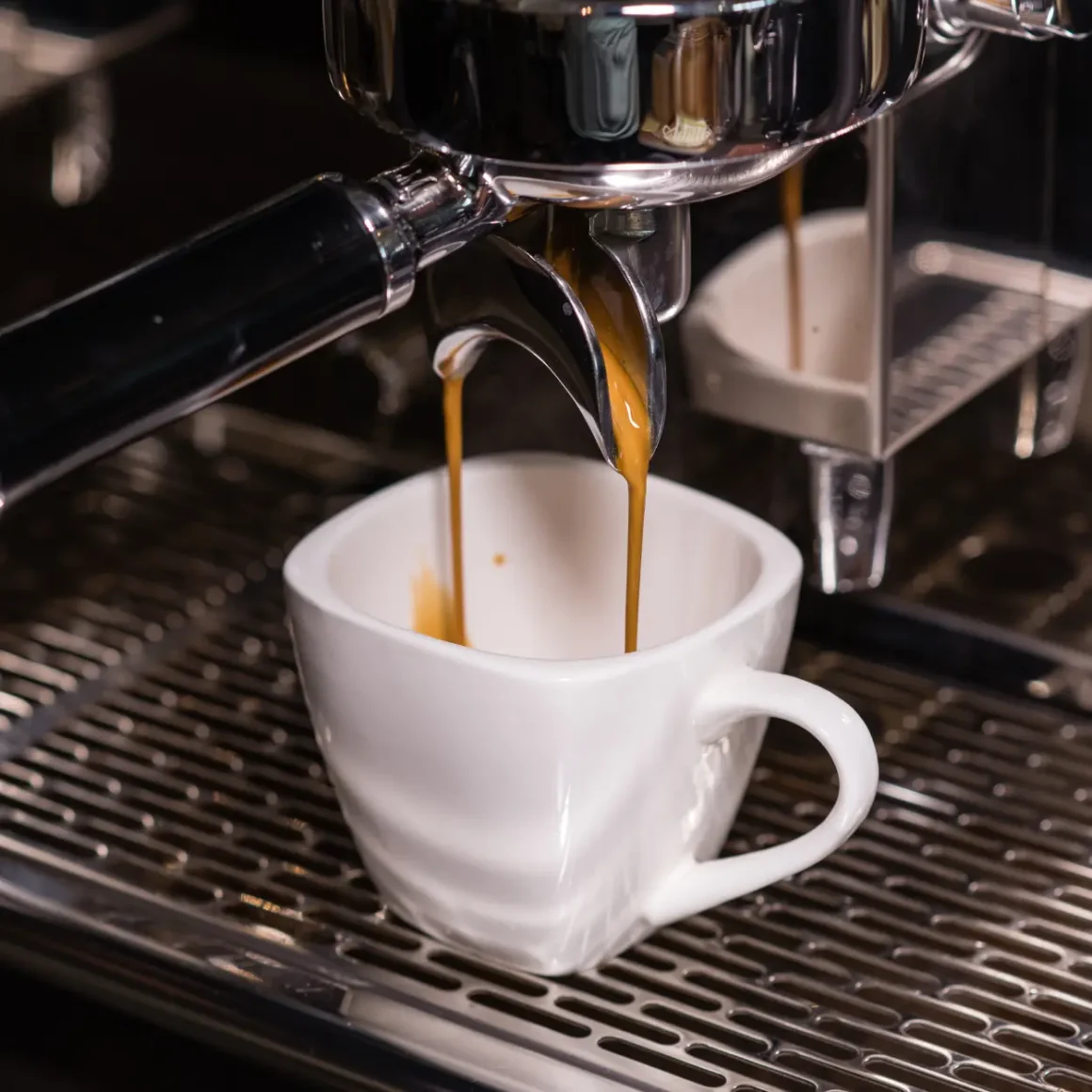 an espresso machine pouring mocha in a cup