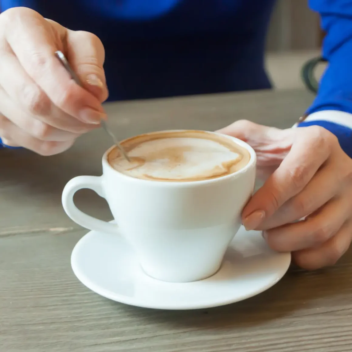 barista mixing a macchiato coffee