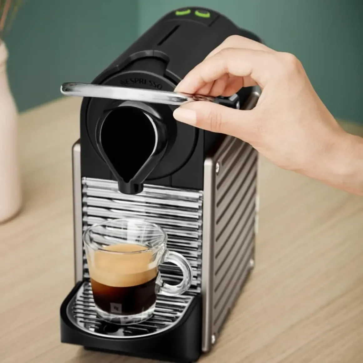 a person using a nespresso pixie espresso machine