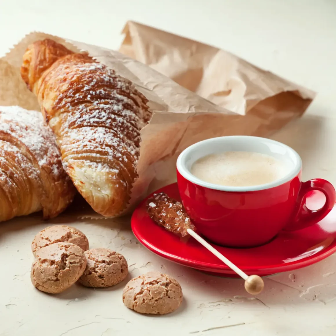 a cup of latte and croissants
