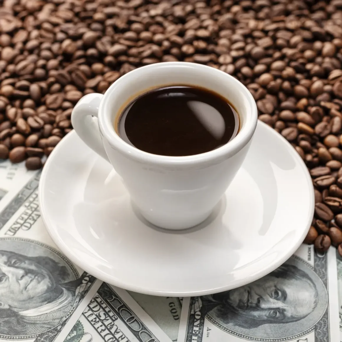 a cup of coffee on a saucer and money