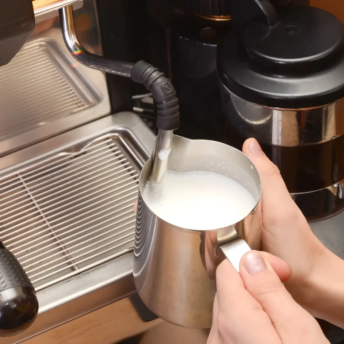 a person forthing milk in a machine
