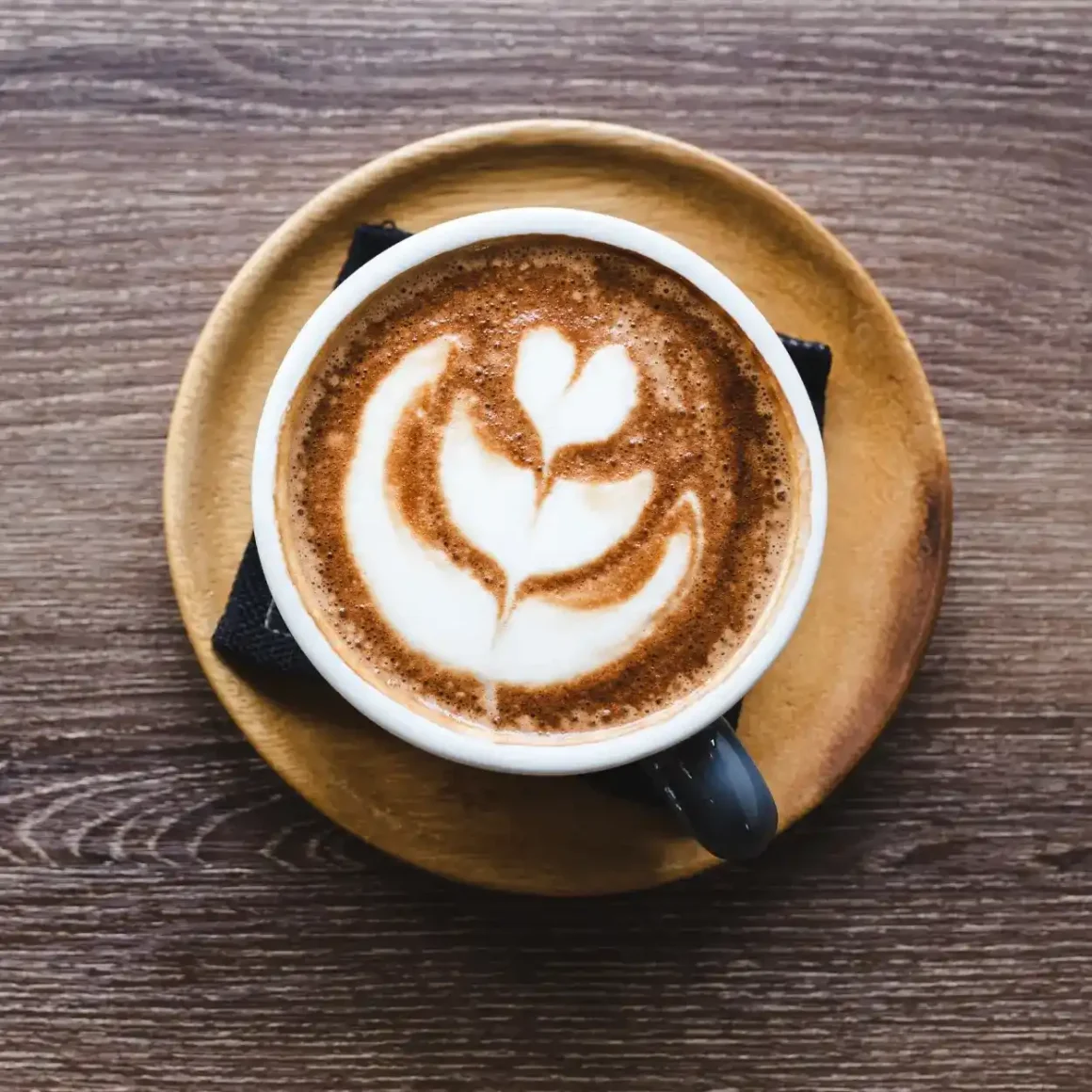 a cup of mocha with a design in the foam