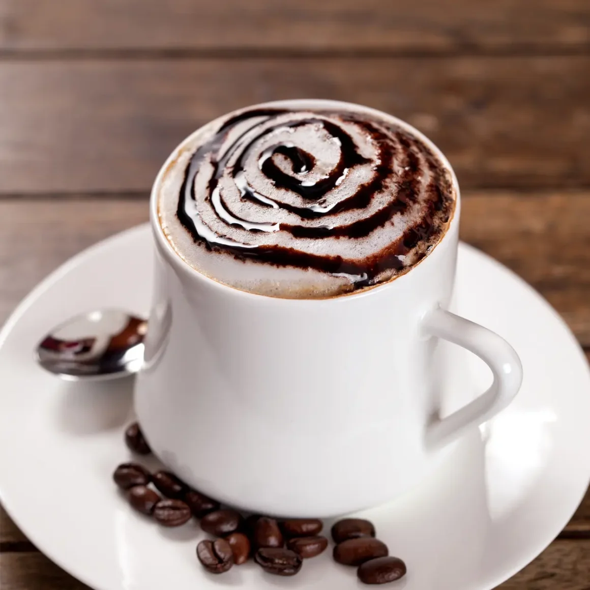 a cup of mocha with a swirl of chocolate on top