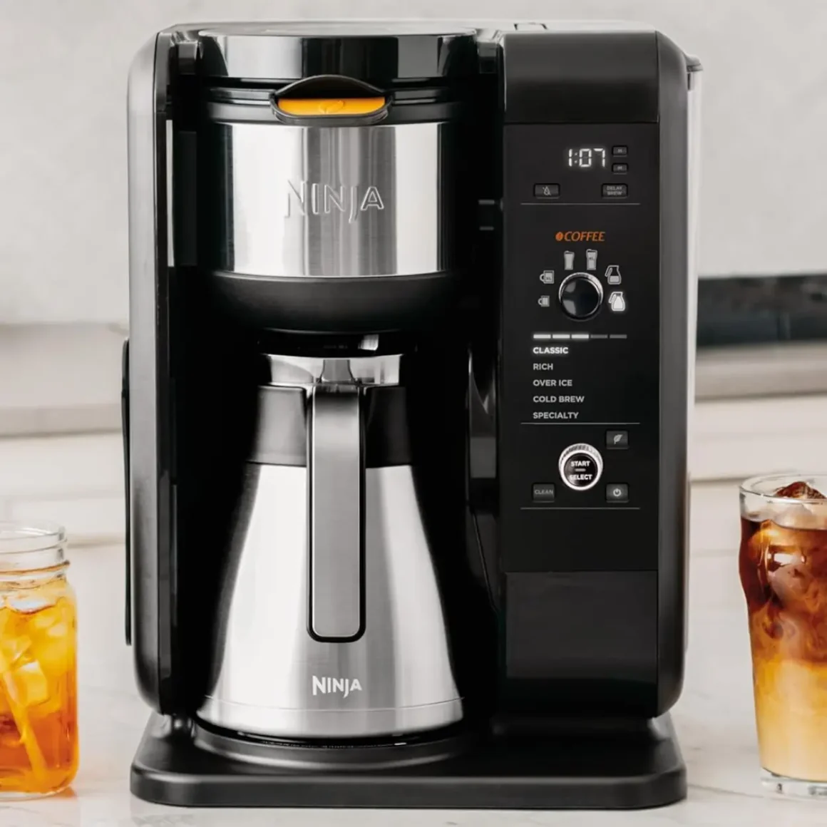 a ninja cp307 coffee maker and a glass of iced coffee