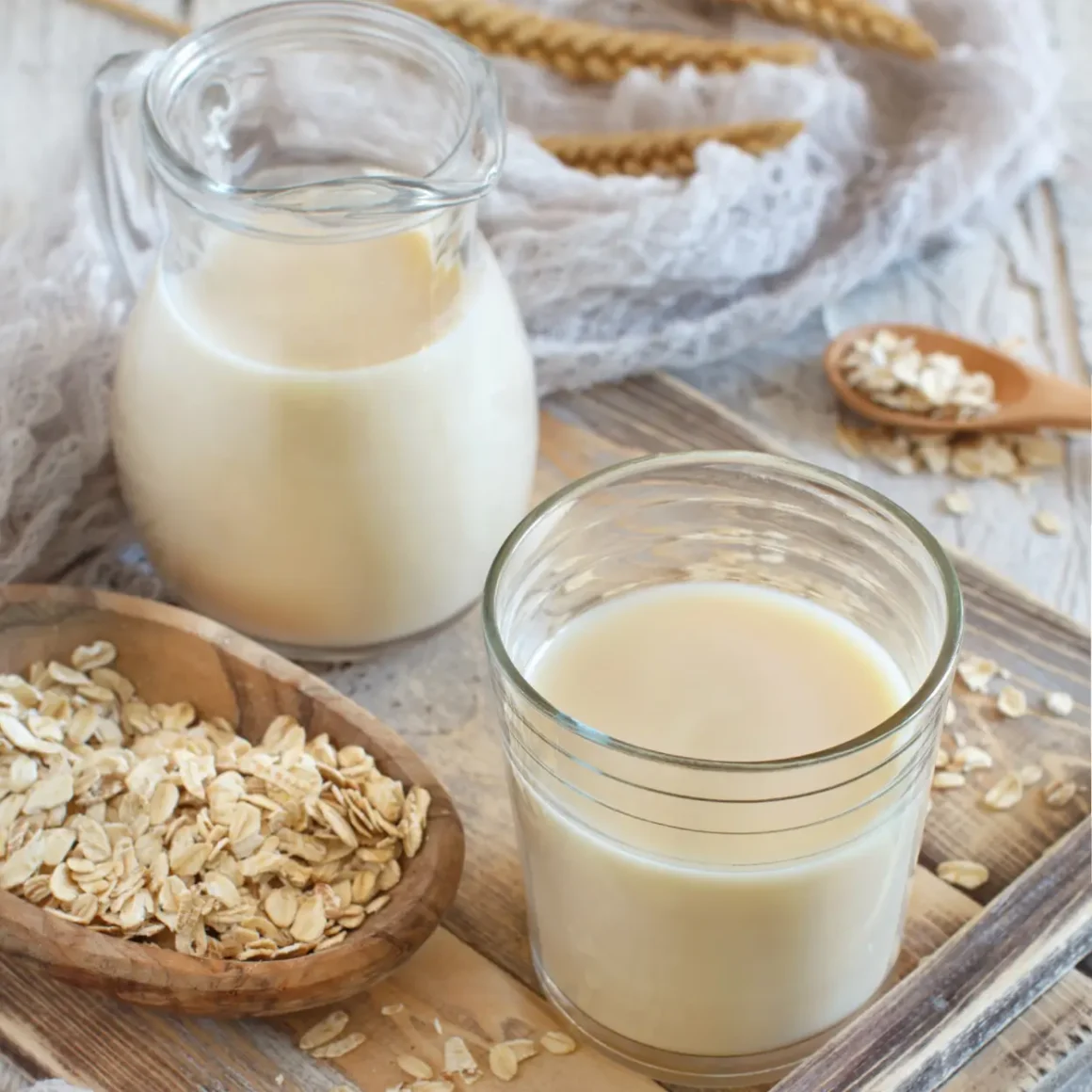 a glass of oat milk and oatmeal on a tray
