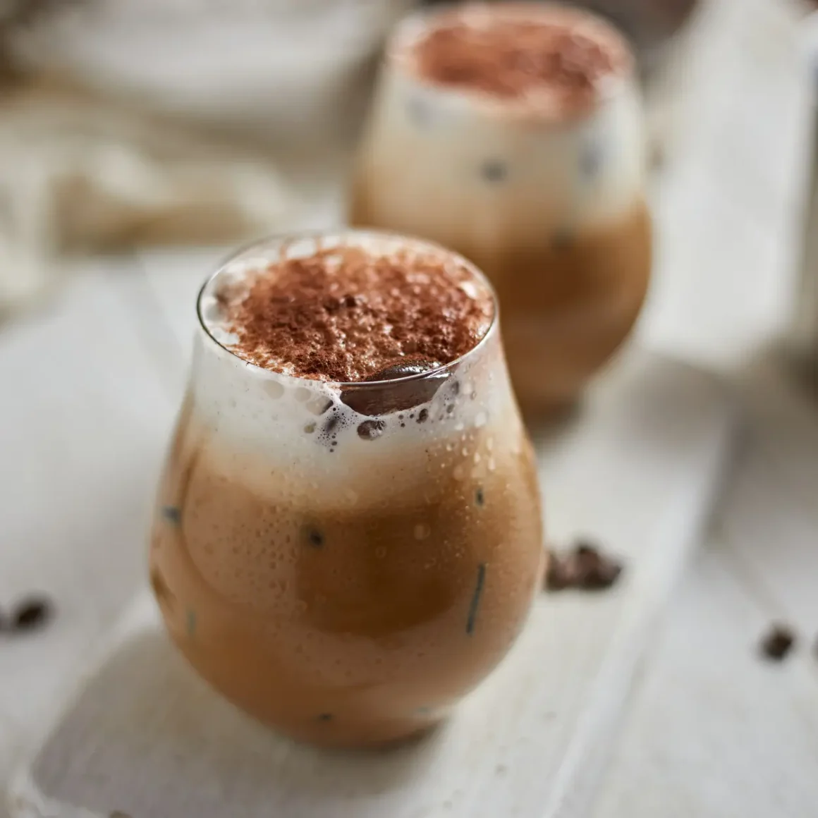 a glass of oat milk cappuccino with foam on top cappuccino