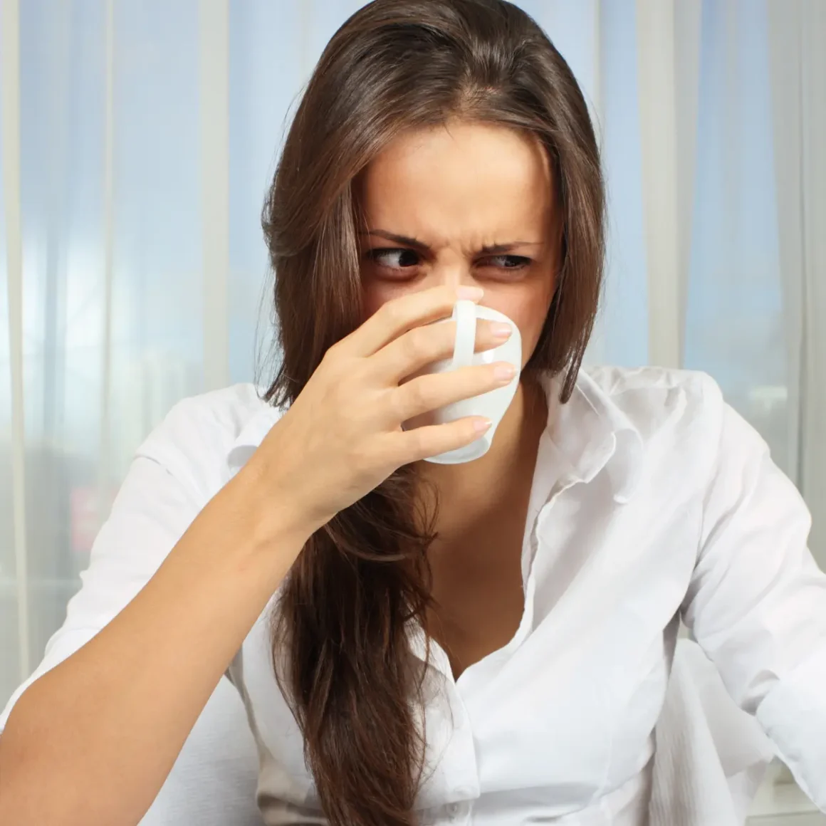 a woman drinking from a cup