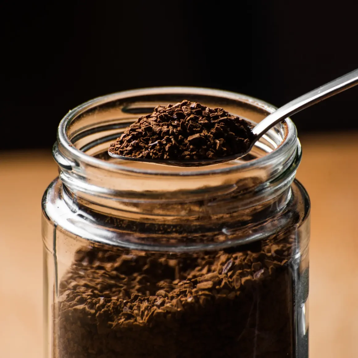 a spoonful of espresso coffee powder in a jar