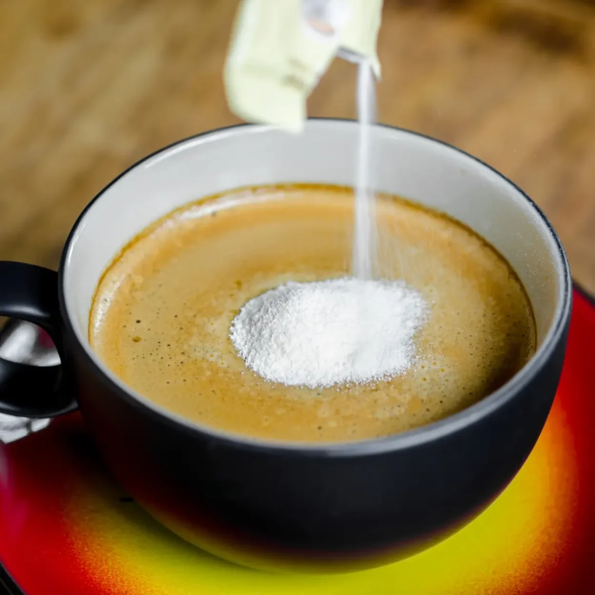 a cup of coffee with powdered coffee creamer in it