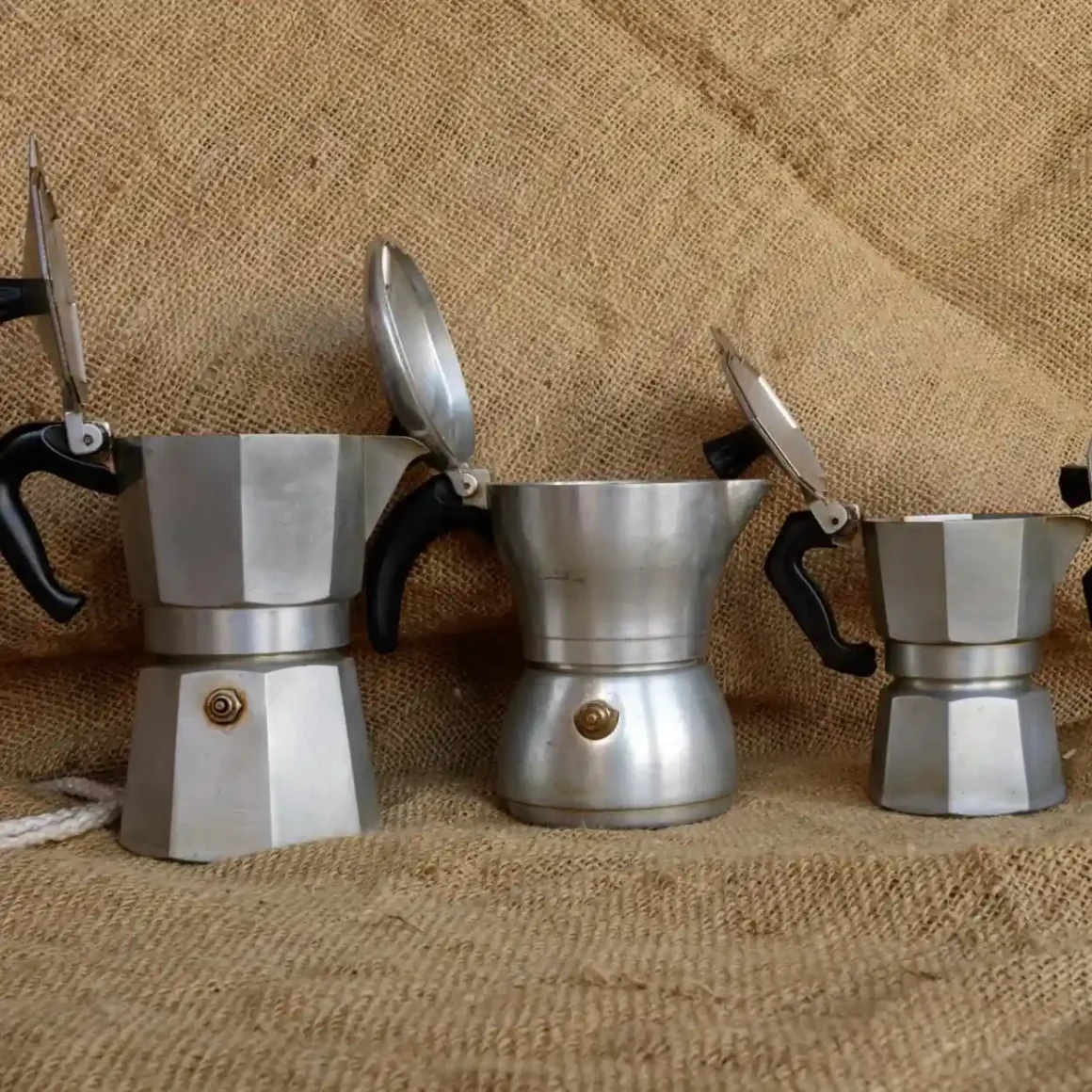 a group of moka pots with a lid open