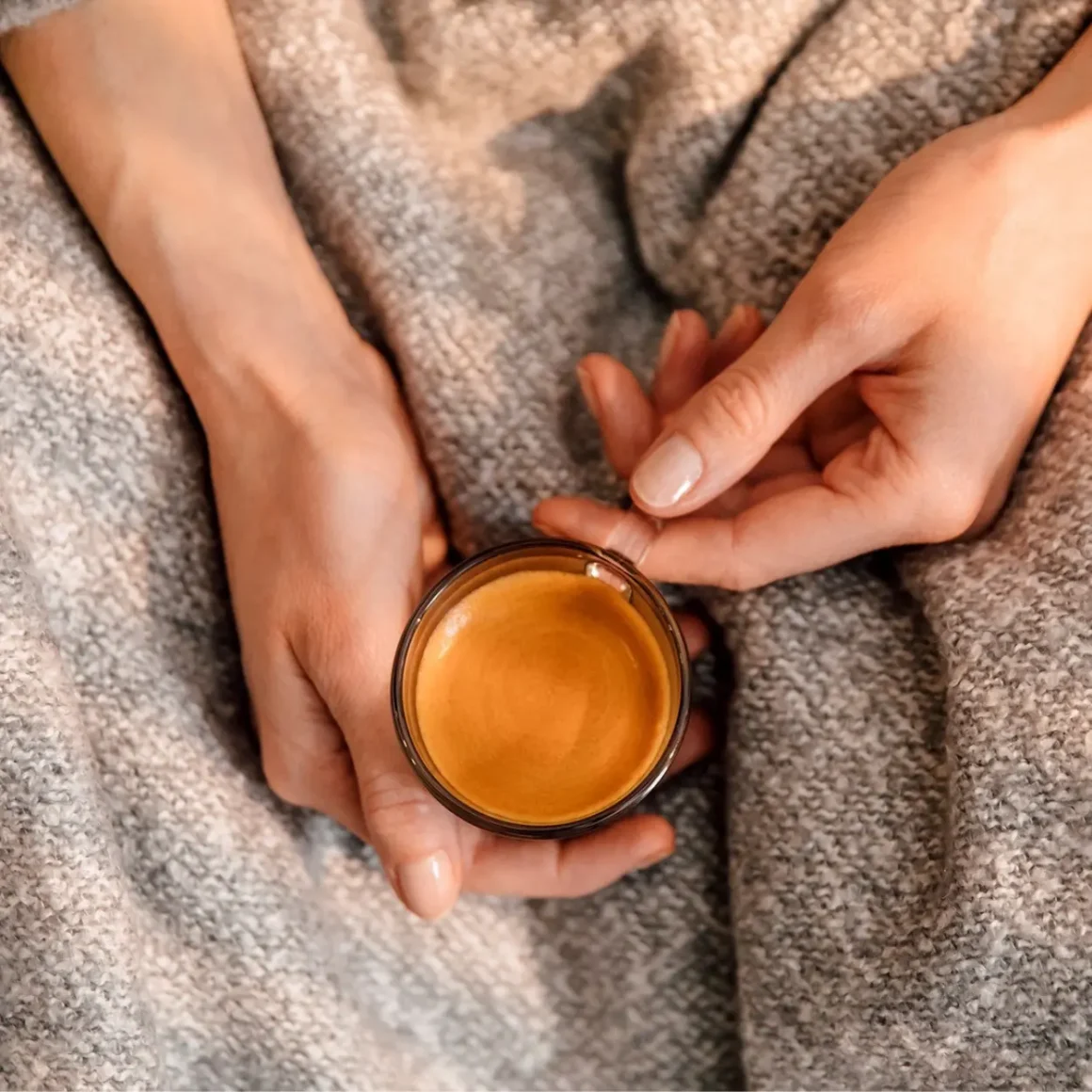 a person holding a cup of coffee