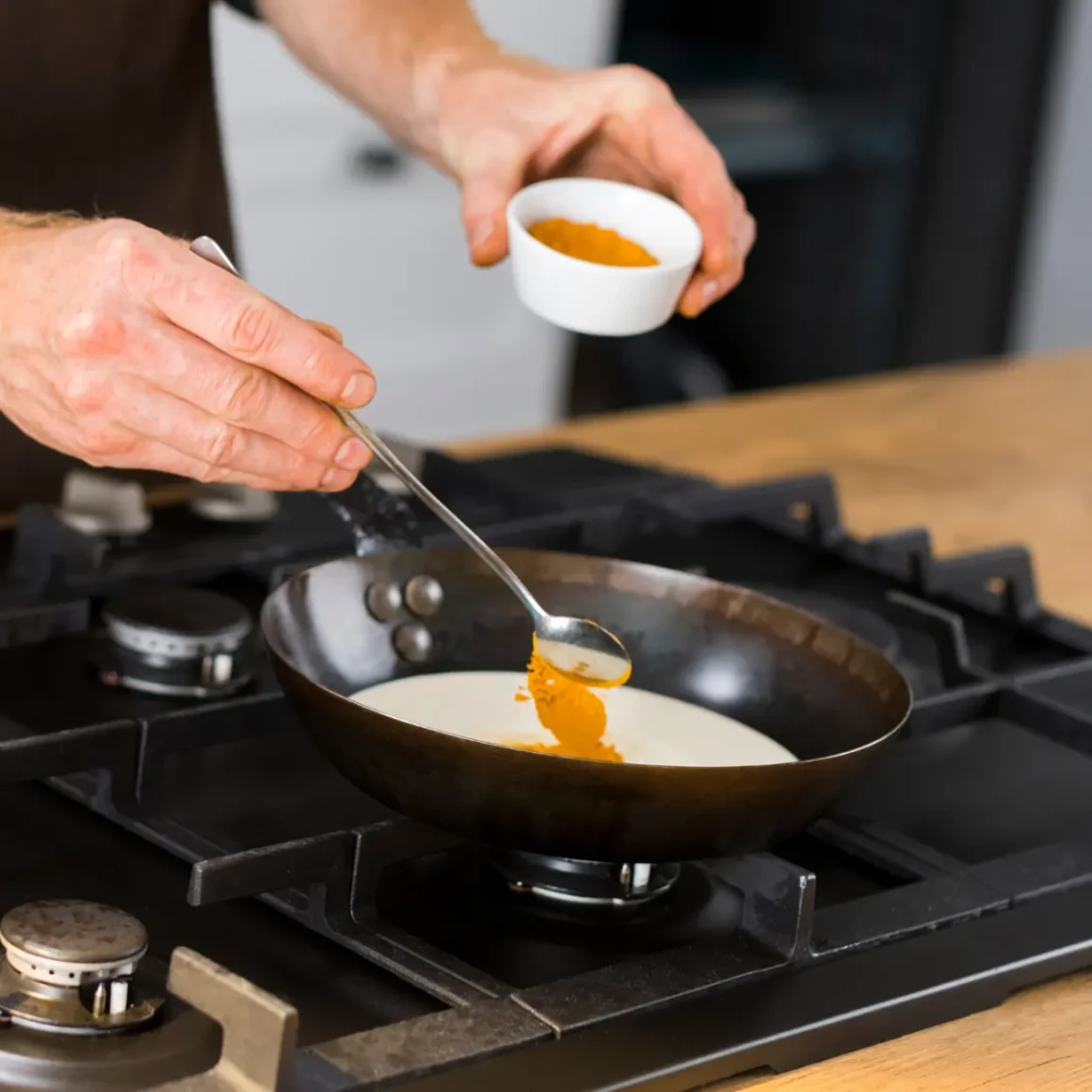 a person cooking food on a stove